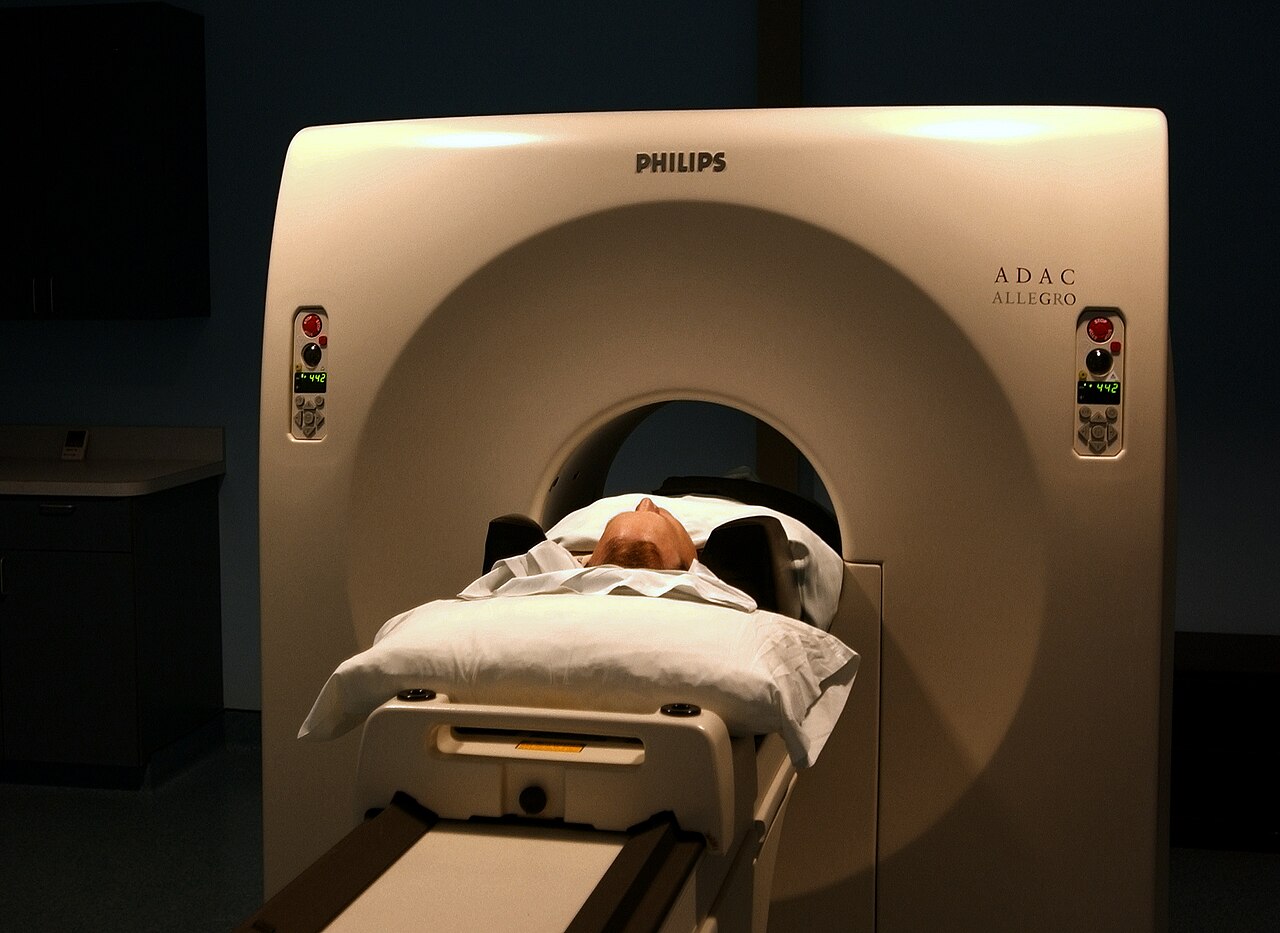 A patient entering a PET scanner
